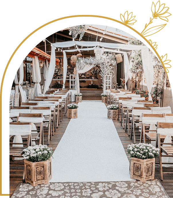 A wedding ceremony with white flowers and chairs.