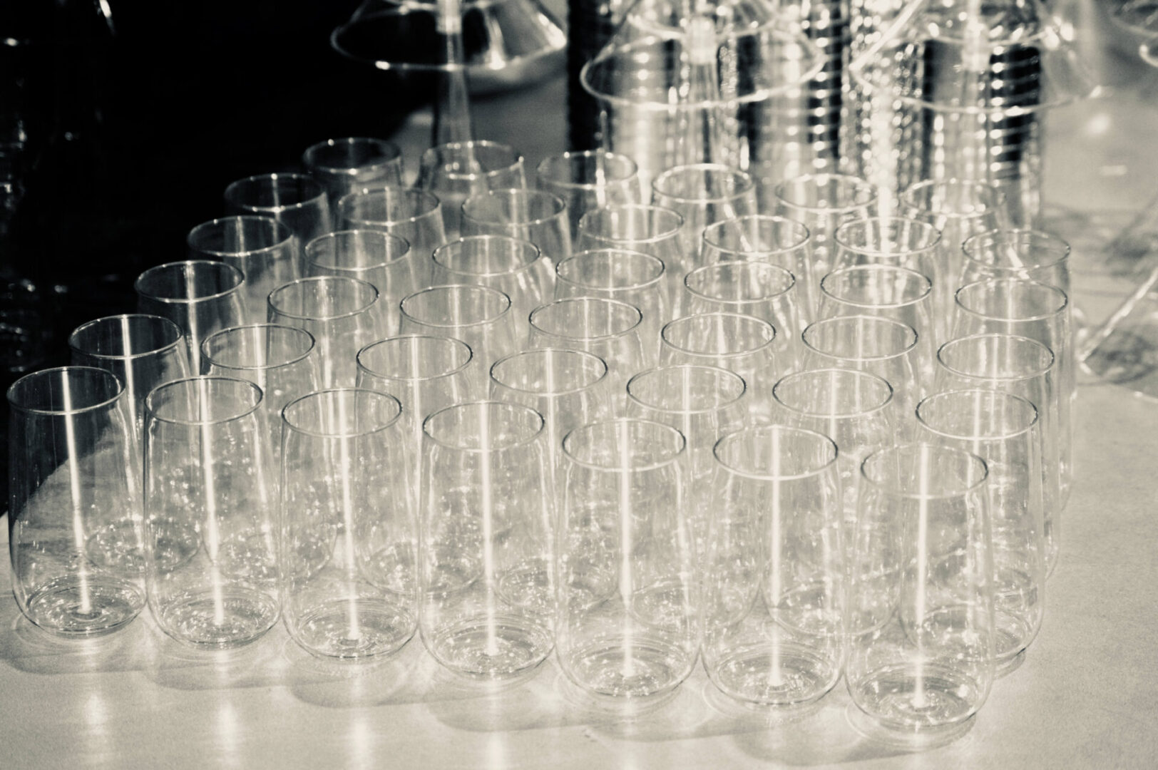 A table filled with many empty wine glasses.