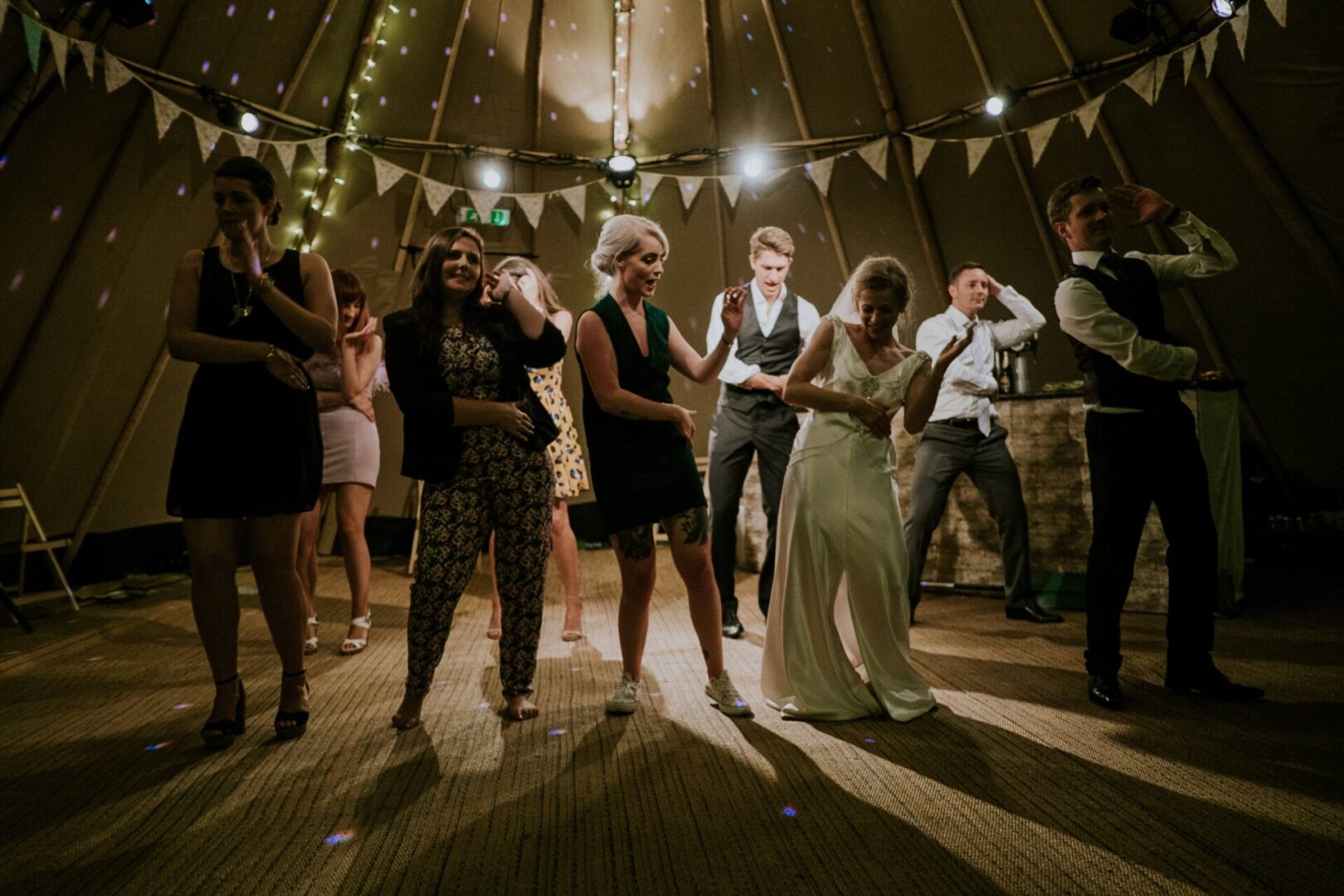 A group of people dancing in a room.