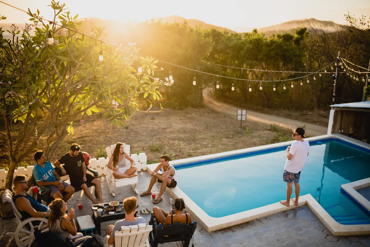 A group of people sitting around a pool.