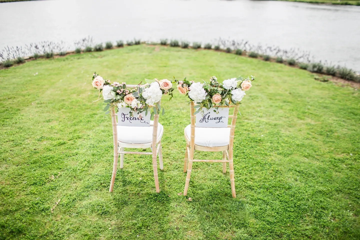 Two chairs with flowers on them in a field