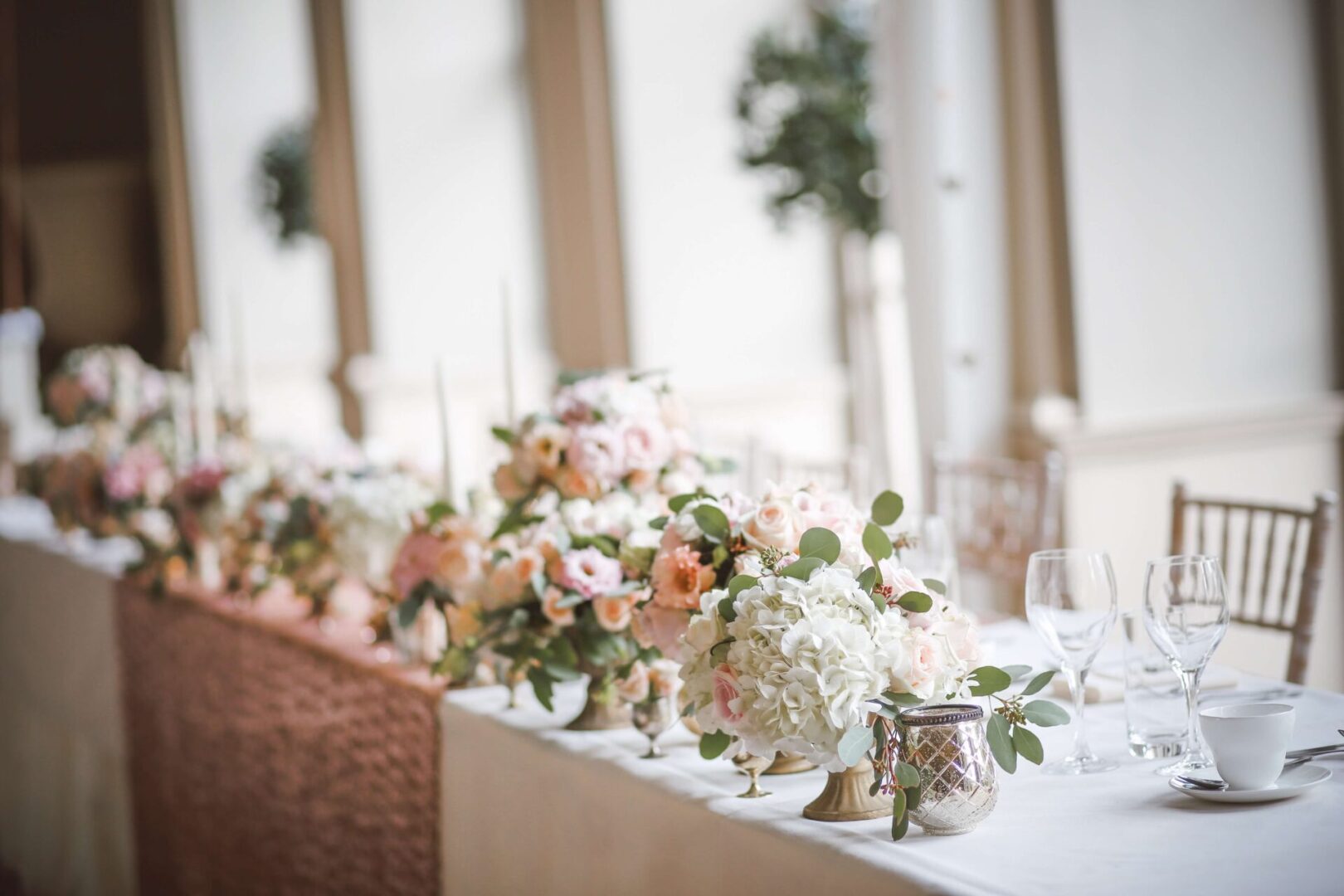 A table with flowers and candles on it